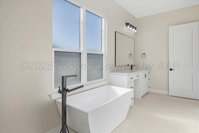 5805 Sheridan St, Amarillo, TX 79119 - full bath with vanity, baseboards, marble finish floors, and a freestanding bath
