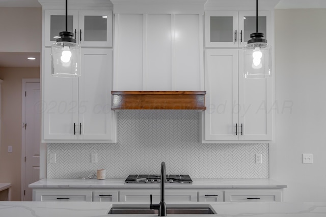 5805 Sheridan St, Amarillo, TX 79119 - kitchen featuring a sink, backsplash, white cabinets, and glass insert cabinets
