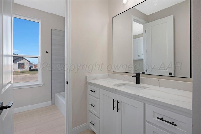 5805 Sheridan St, Amarillo, TX 79119 - bathroom featuring vanity, baseboards, and a tub to relax in