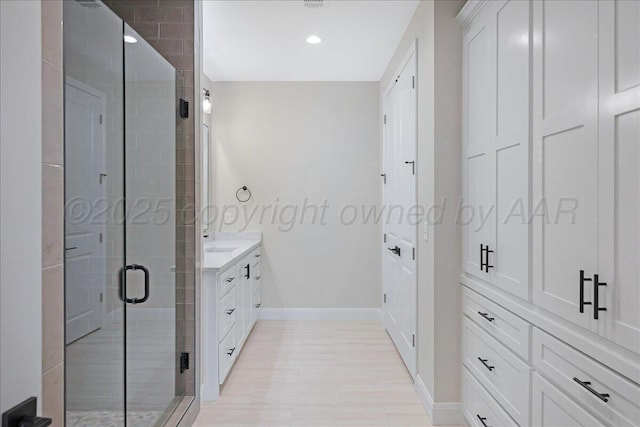5805 Sheridan St, Amarillo, TX 79119 - full bathroom with a shower stall, vanity, baseboards, recessed lighting, and wood finished floors