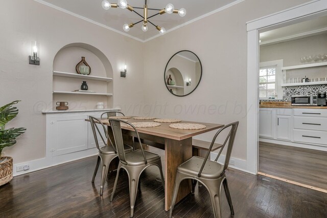 505 S Belleview St, Amarillo, TX 79106 - dining space featuring a chandelier, dark wood finished floors, crown molding, built in shelves, and baseboards