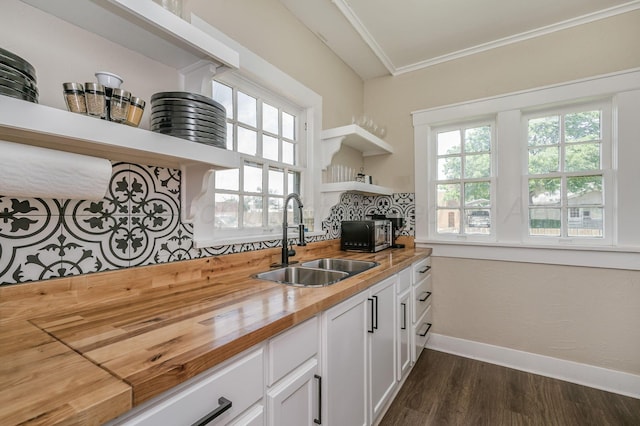 505 S Belleview St, Amarillo, TX 79106 - kitchen featuring open shelves, butcher block counters, a sink, baseboards, and dark wood-style flooring