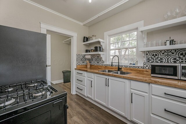 505 S Belleview St, Amarillo, TX 79106 - kitchen featuring open shelves, black range with gas stovetop, wood counters, stainless steel microwave, and crown molding