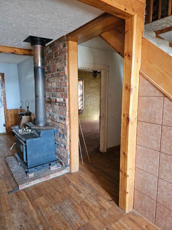 interior space with hardwood / wood-style flooring and wood walls