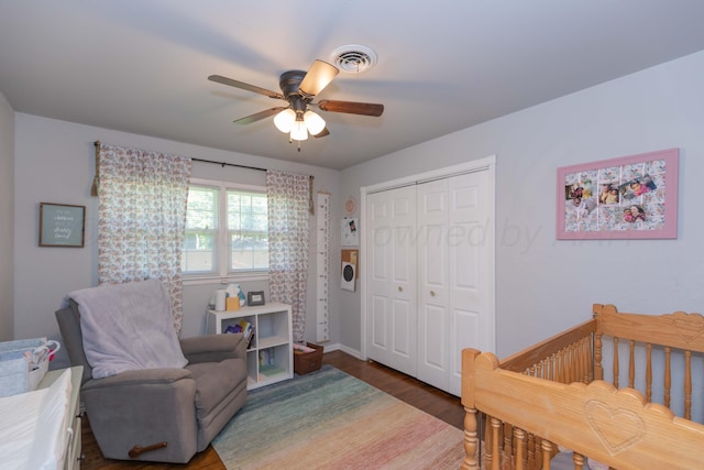 bedroom featuring wood finished floors, a closet, ceiling fan, and baseboards