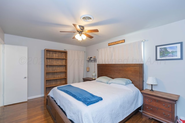 bedroom featuring dark wood-style flooring, ceiling fan, and baseboards