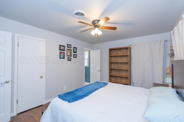 bedroom with dark wood finished floors, baseboards, and a ceiling fan
