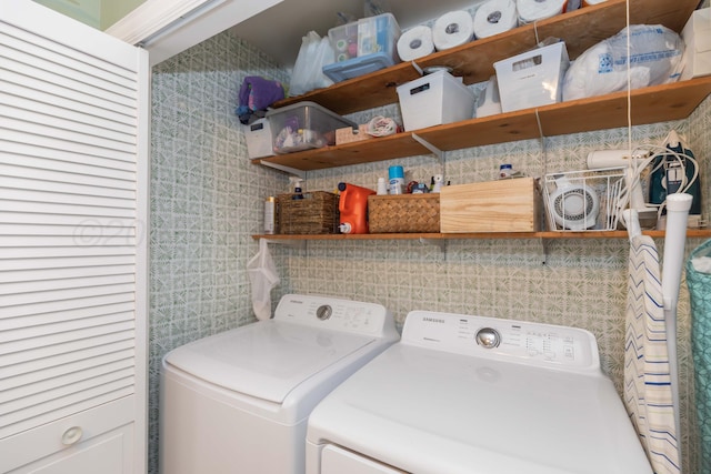 laundry area with washing machine and dryer and tile walls
