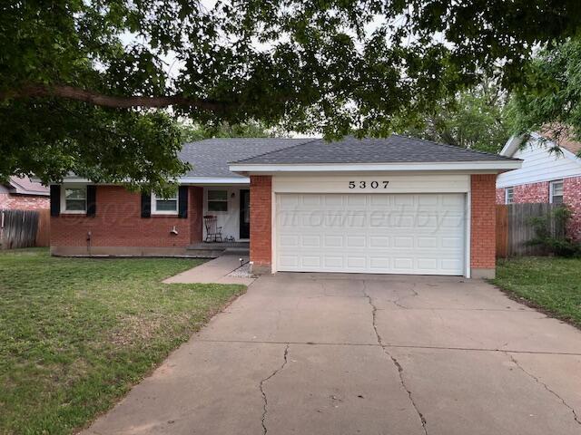 ranch-style home with brick siding, driveway, and a garage
