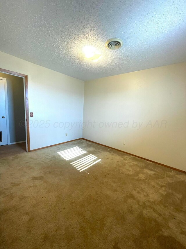 708 N Arizona St, Shamrock, TX 79079 - empty room featuring carpet and a textured ceiling