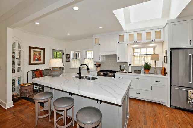 2215 S Hughes St, Amarillo, TX 79109 - kitchen with stainless steel appliances, a sink, light stone countertops, a kitchen breakfast bar, and recessed lighting