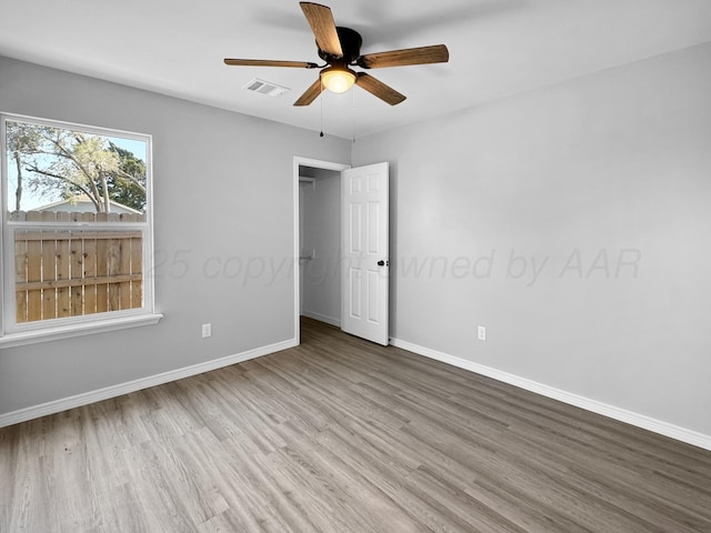 unfurnished bedroom with ceiling fan and hardwood / wood-style floors