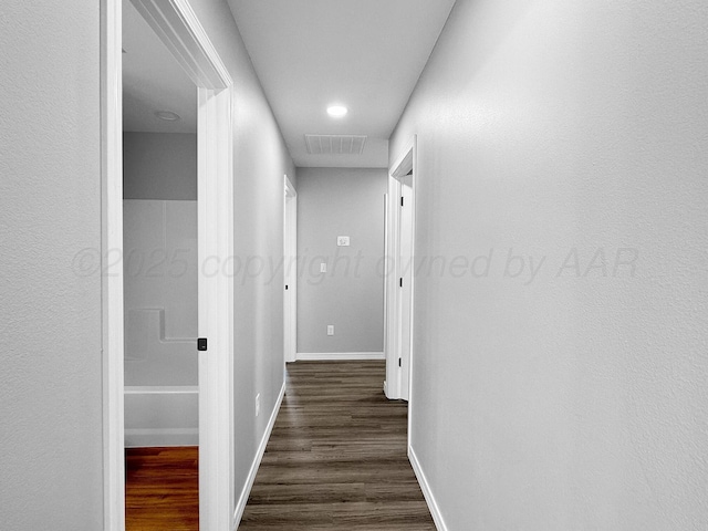 corridor with dark hardwood / wood-style floors