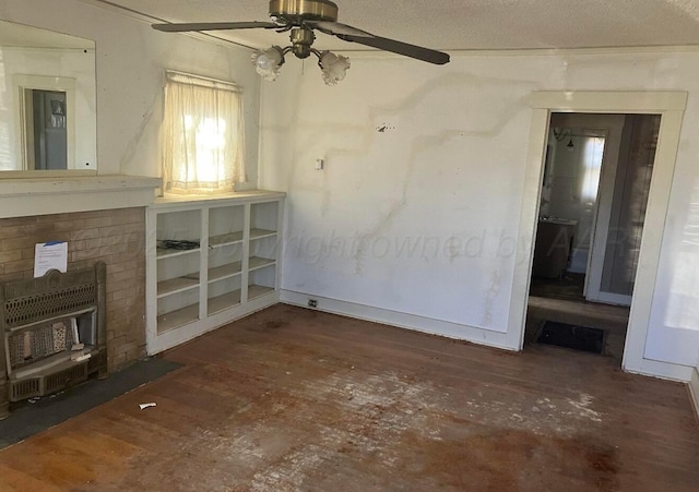 unfurnished living room with a textured ceiling, dark wood finished floors, and a ceiling fan