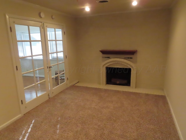 unfurnished living room featuring baseboards, a fireplace, and carpet flooring