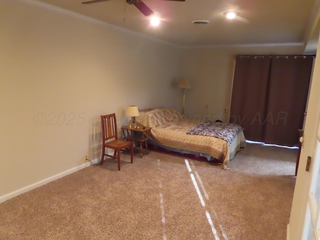 carpeted bedroom with crown molding, baseboards, and visible vents