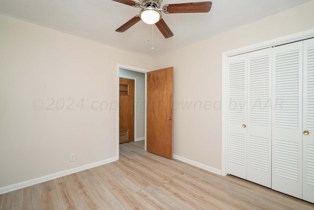 unfurnished bedroom featuring ceiling fan, a closet, and light hardwood / wood-style flooring