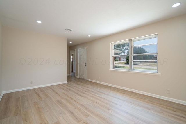 unfurnished room with light hardwood / wood-style flooring