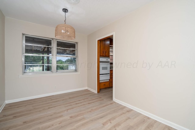 empty room with light hardwood / wood-style flooring