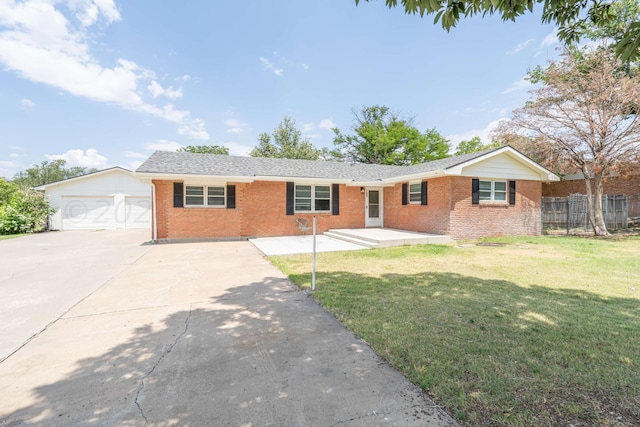 ranch-style home featuring a garage and a front lawn