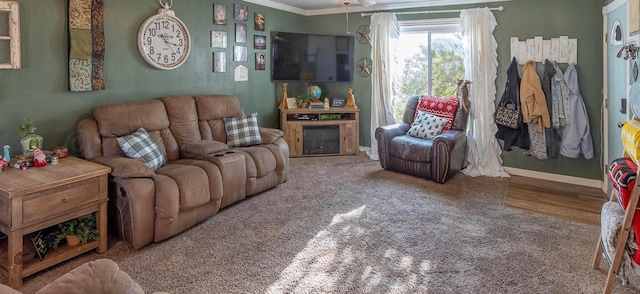 living room with hardwood / wood-style flooring and crown molding