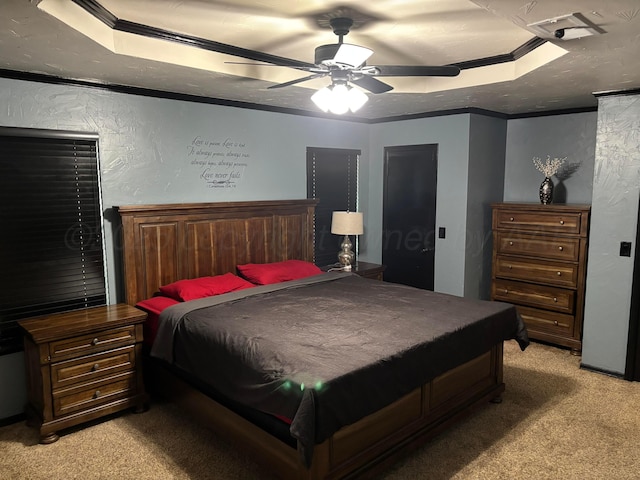 7810 Farrell Dr, Amarillo, TX 79121 - bedroom featuring a tray ceiling, light colored carpet, crown molding, a textured wall, and ceiling fan