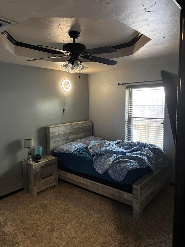7810 Farrell Dr, Amarillo, TX 79121 - carpeted bedroom featuring ceiling fan and a tray ceiling