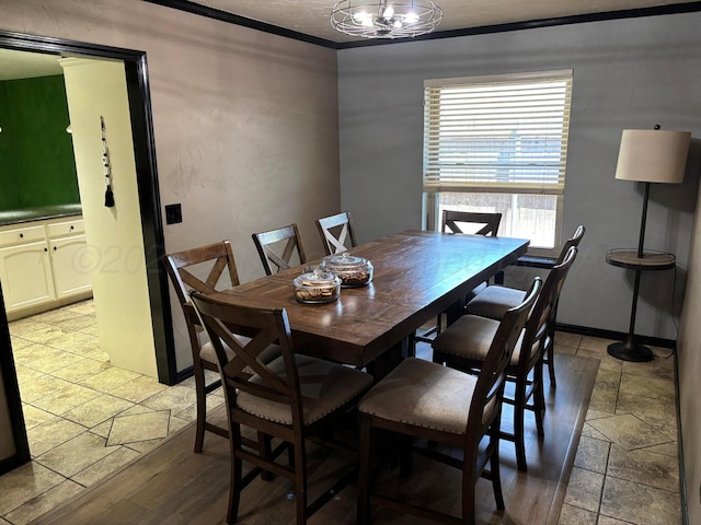 7810 Farrell Dr, Amarillo, TX 79121 - dining area featuring crown molding, stone tile floors, and a chandelier