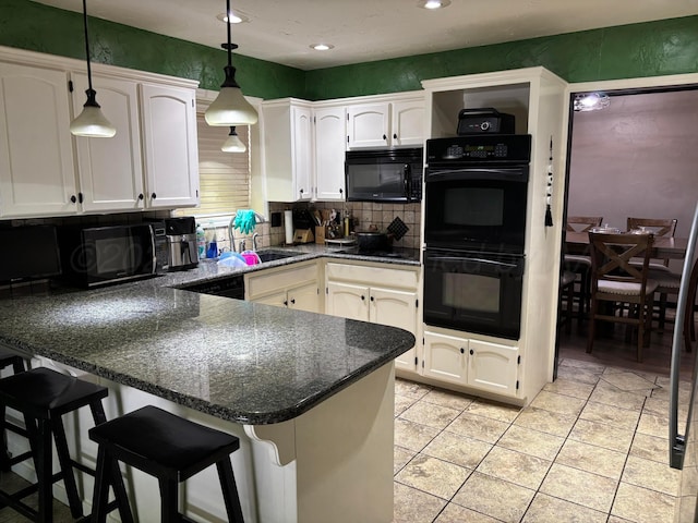 7810 Farrell Dr, Amarillo, TX 79121 - kitchen with black appliances, a peninsula, white cabinetry, hanging light fixtures, and backsplash