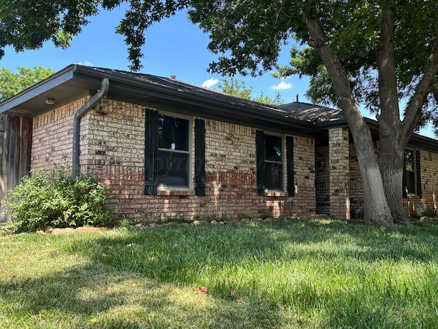 7810 Farrell Dr, Amarillo, TX 79121 - view of property exterior with brick siding and a yard
