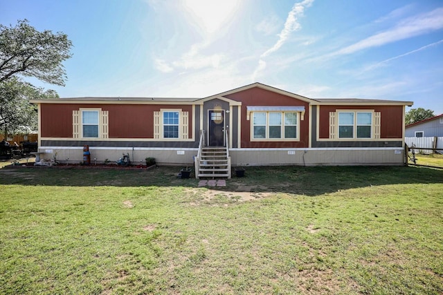 manufactured / mobile home with entry steps and a front lawn