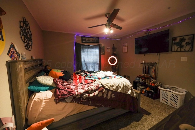 bedroom with a ceiling fan and carpet