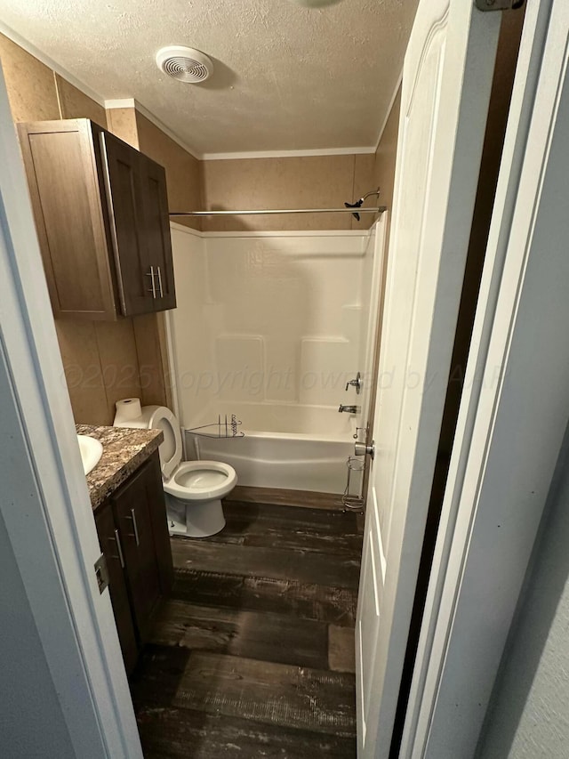 bathroom with visible vents, bathing tub / shower combination, toilet, wood finished floors, and vanity