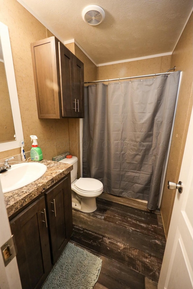 bathroom with visible vents, a shower with curtain, wood finished floors, a textured ceiling, and vanity