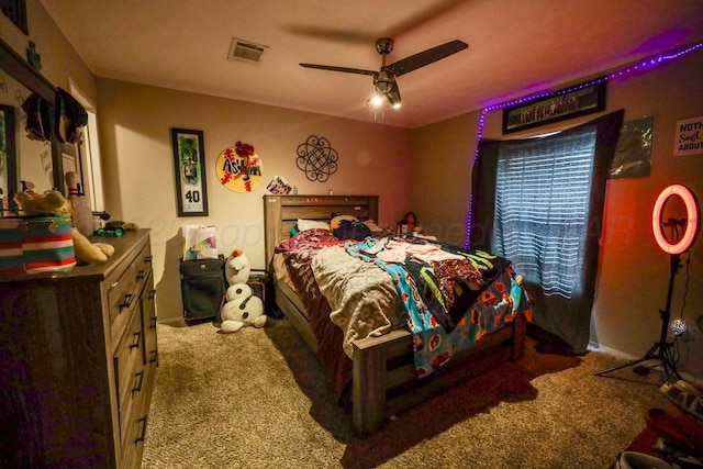 carpeted bedroom with ceiling fan, visible vents, and baseboards