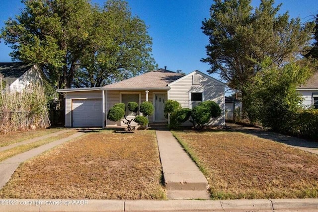 view of front of house with a garage and a front yard