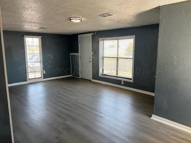 2617 W Amarillo Blvd, Amarillo, TX 79106 - unfurnished room with a textured ceiling and wood finished floors