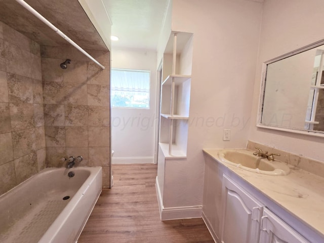 full bathroom with baseboards, shower / tub combination, vanity, and wood finished floors