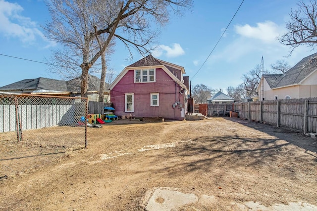 back of house featuring a fenced backyard