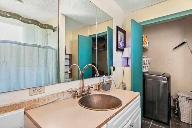 full bathroom with washer / clothes dryer, toilet, a textured ceiling, vanity, and tile patterned floors