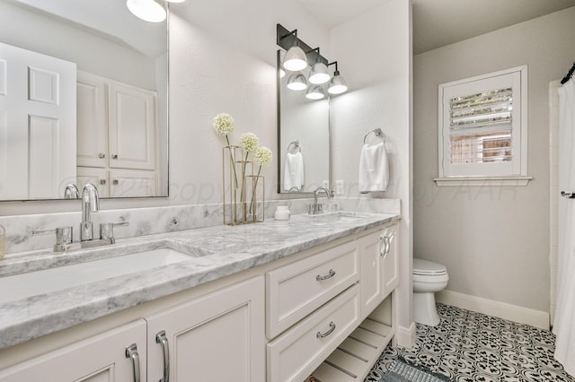 bathroom with vanity, toilet, and tile patterned flooring