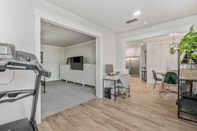 interior space with light hardwood / wood-style flooring and ornamental molding