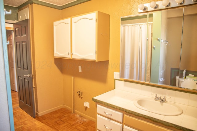 bathroom with vanity, curtained shower, and parquet floors