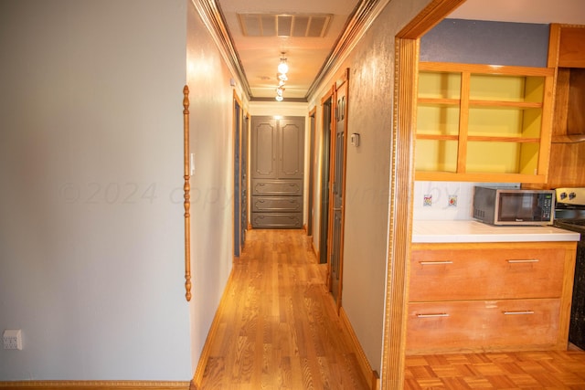 hallway with light hardwood / wood-style flooring and crown molding