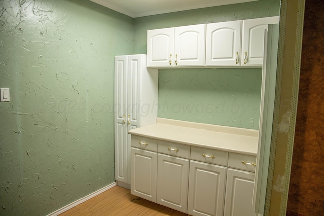 interior space featuring hardwood / wood-style floors and ornamental molding