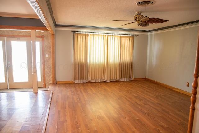 entrance foyer with a textured ceiling, ceiling fan, crown molding, and hardwood / wood-style floors