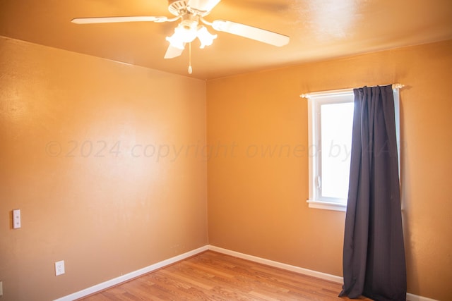 empty room featuring ceiling fan and hardwood / wood-style flooring