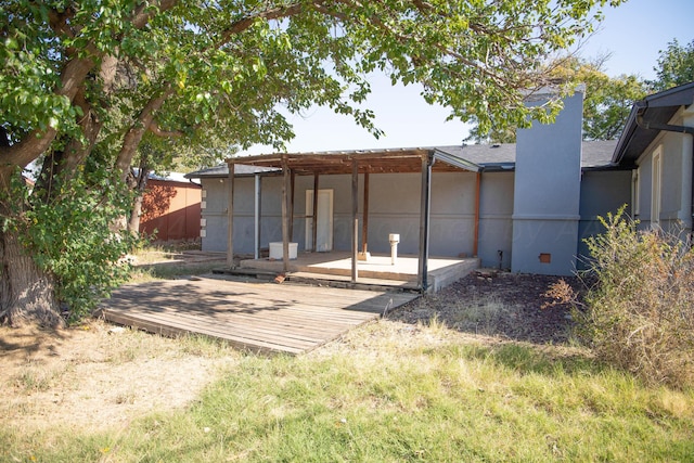 rear view of house with a wooden deck