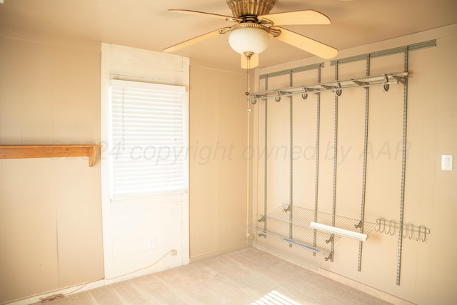 interior space featuring light colored carpet and ceiling fan