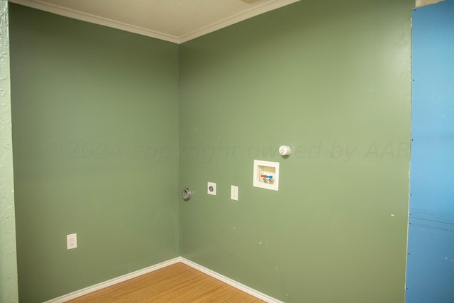 laundry room with hookup for an electric dryer, wood-type flooring, crown molding, and washer hookup